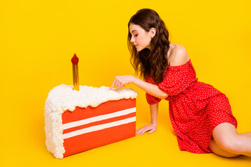 Poster - Profile side photo of young girl sit floor finger touch cake birthday yummy isolated over yellow color background