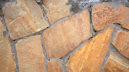 Wall Mural - Fragment of a wall from a chipped stone, stone wall texture. decorative stone, different colors.