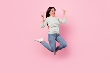 Poster - Full body photo of cheerful positive woman jump up air show v-sign good mood isolated on pink color background