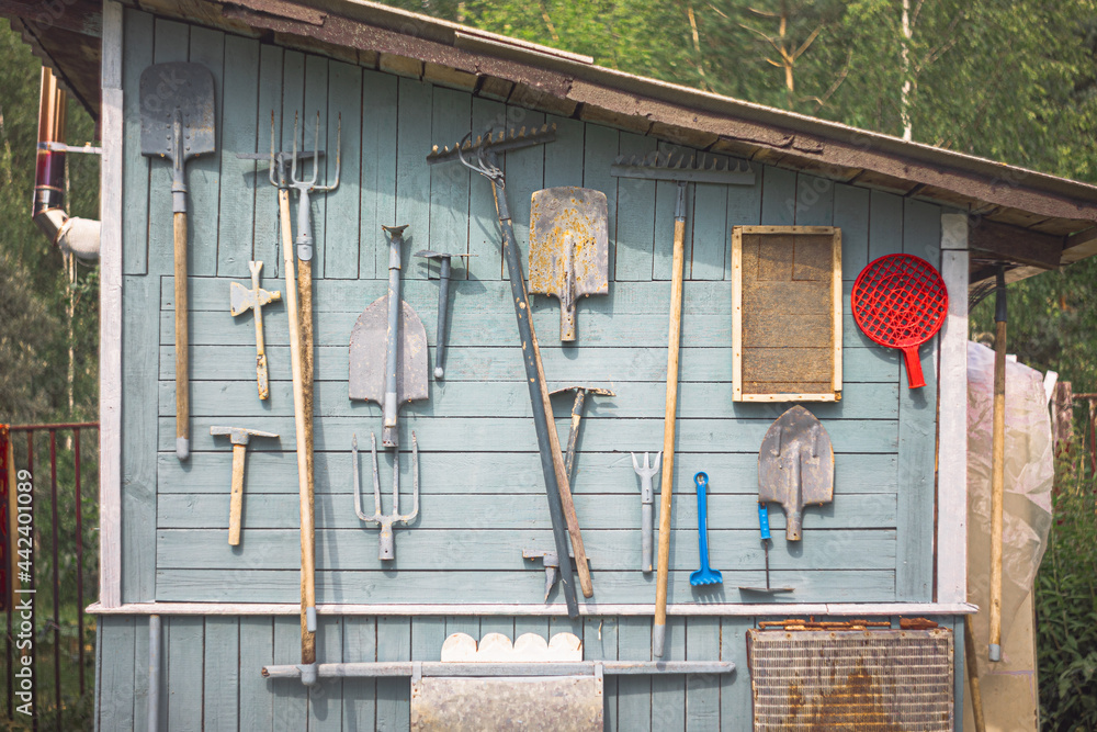 a board with tools on the wall of the shed - obrazy, fototapety, plakaty 