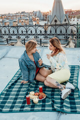 Two young girls on picnic on rooftop