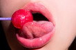 Licking tongue lips. Lips with candy, sexy sweet dreams. Oral sex blow job concept. Female mouth licks chupa chups, sucks lollipop.