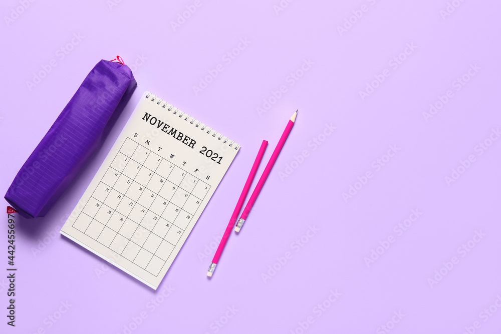 Flip paper calendar, pencils and case on color background