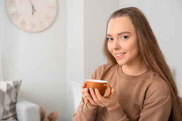 Poster - Beautiful woman with cup of coffee at home