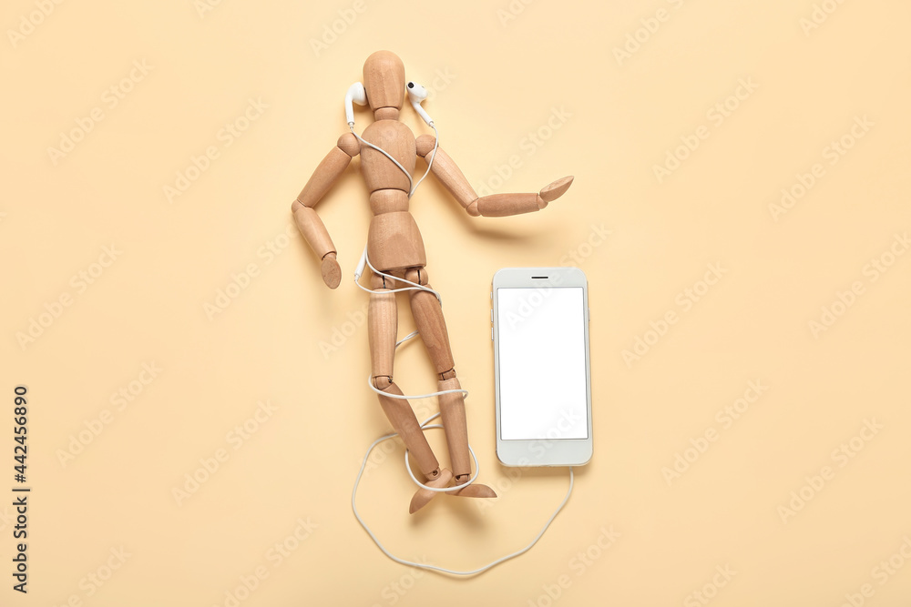 Mannequin with modern earphones and mobile phone on color background