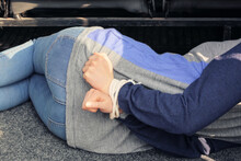 Female Hostage With Tied Hands Lying Inside Car, Closeup