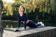 © fotofabrika - Fit young woman exercising on mat in the park