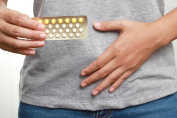 woman taking pills for birth control