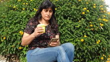 Portrait Of Mature Woman Using Mobile Phone In Park