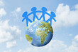 © Leo Lintang - Blue people paper holding hands standing on earth