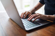 © Farknot Architect - Closeup image of a woman working and typing on laptop computer keyboard on the table