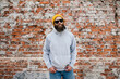 © San4ezz007 - City portrait of handsome hipster guy with beard wearing gray blank hoodie or sweatshirt and hat with space for your logo or design. Mockup for print