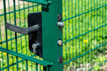 Fragment Of A Gate Of A Metal Fence With A Lock And A Handle. Restriction, Security Concept.