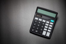 Black Calculator On Black Background. Top View.