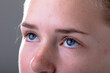 © WavebreakMediaMicro - Close up of blue eyes of caucasian businesswoman, isolated on grey background