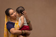 © IndiaPix - A woman holding her baby with affection.