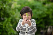 © lalalululala - Asian Child Holding Young Plant In Hands With Nature Background