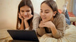 © Kyrylo Ryzhov - Two teenage girls chatting during educational video conference. Remote studying and communication from home