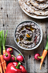 Wall Mural - Homemade Black Bean Dip by some fresh vegetables