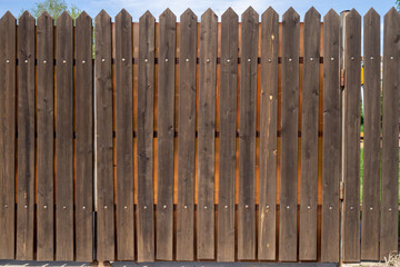 Wooden plank fence with metal rivets. Background with copy space