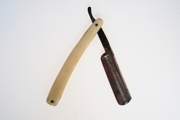 vintage old razor dirty ivory handle with rust on  blade on white background, Isolated vintage retro blade in barber shop