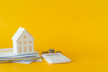 Close Up Of Home Model And Calculator And Invoice Letter On Yellow Background With Space For Money Management ,home Loan And Personal Financial Concept	