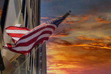 American Flag Street Sign In New York With New York During Sunset