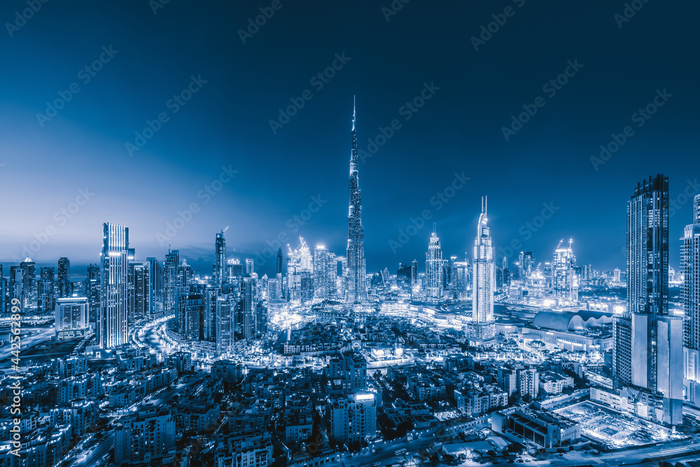 Aerial view of Dubai Downtown skyline, highway roads or street in United Arab Emirates or UAE. Financial district and business area in smart urban city. Skyscraper and high-rise buildings at sunset. - obrazy, fototapety, plakaty 