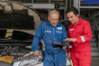 © godji10 - Elderly vehicle mechanic use an obd2 car diagnostics device scanner to interpreting automotive error codes. Senior professional mechanic maintenance the engine in garage workshop. Auto repair service