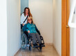 © ADDICTIVE STOCK - Adult daughter with aged mother in wheelchair in clinic