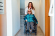 © ADDICTIVE STOCK - Adult daughter with aged mother in wheelchair in clinic