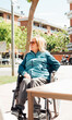 © ADDICTIVE STOCK - Thoughtful senior woman in wheelchair in city