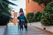 © ADDICTIVE STOCK - Aged mother in wheelchair and daughter during walk