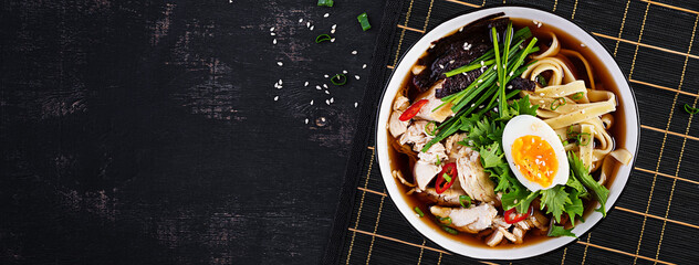 Miso soup. Japanese ramen soup with chicken, egg, nori and  nipposinica on dark background. Top view, flat lay, banner