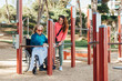 © ADDICTIVE STOCK - Woman with aged mother in wheelchair on sports ground