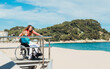 © ADDICTIVE STOCK - Adult daughter with aged mother in wheelchair on seashore