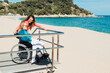 © ADDICTIVE STOCK - Adult daughter with aged mother in wheelchair on seashore