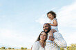 © ADDICTIVE STOCK - Content multiracial family in summer field