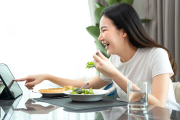 Cheerful young Asian woman happy eating healthy food