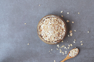 Healthy breakfast Organic oat flakes in a wooden bowl Top view Copy space