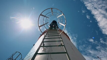 Wall Mural - Male worker up the ladder is for inspection shell plate top of storage tank chemical.