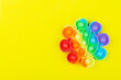 pop it, a children's toy for relaxation on a yellow background
