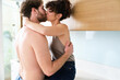 © ADDICTIVE STOCK - Couple kissing in kitchen on counter