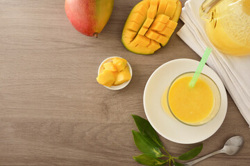 Wall Mural - Background with table with mango juice and fruit top view