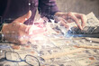 © peshkova - Double exposure of man's hand holding and using a digital device and brain hologram drawing. Data concept.