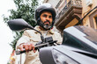 © ADDICTIVE STOCK - Hispanic motorcyclist driving modern bike on city street