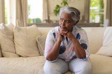 Senior African American Woman Sitting On Sofa And Thinking