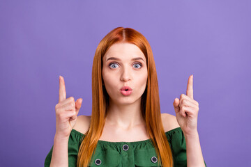 Photo of impressed red hair young lady point empty space wear green open shoulders blouse isolated on violet color background