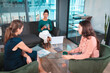 © Wavebreak Media - Group of diverse businesswomen discussing together sitting at glass table and using laptop