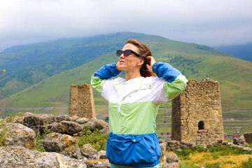 Young woman girl traveller smiling and hiking in the mountains in Caucasus. Freedom lifestyle.